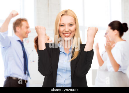 businesswoman celebrating succes in office Stock Photo