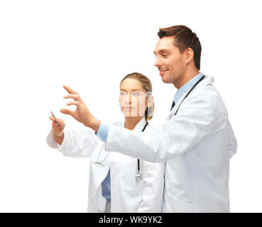 healthcare, medical and technology concept - two young doctors working with something imaginary Stock Photo
