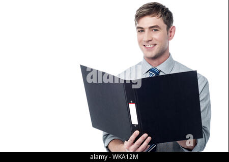 Young businessman reading documents inside a folder Stock Photo