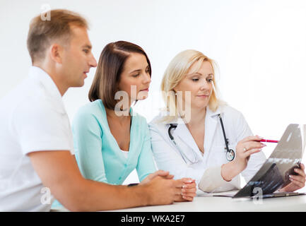 doctor with patients looking at x-ray Stock Photo
