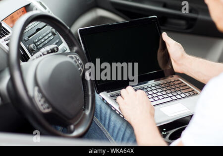 man using laptop computer in car Stock Photo