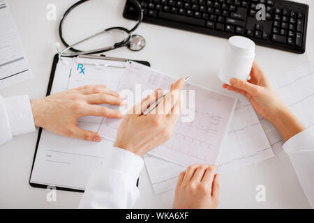 healthcare, hospital and medical concept - two doctors prescribing medication Stock Photo