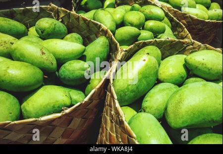 High Angle View Of Raw Mangoes In Baskets