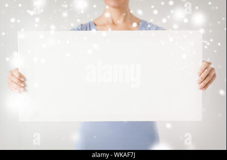 shopping, sale, advertisement, christmas, x-mas concept - woman hands showing white blank board Stock Photo