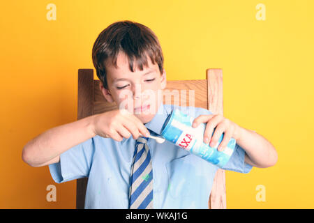 Extracting DNA from a Strawberry Science strawberry DNA extraction Experiment with Young Boy doing experiment in School Uniform Stock Photo