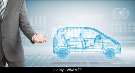 Businessman points hand on wire frame car. High-tech graphs at backdrop Stock Photo