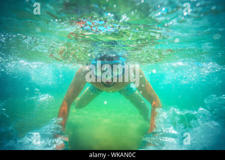 Young man, swimming underwater Stock Photo