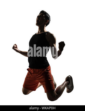 Excited young athletic man kneeling, isolated on white. Stock Photo