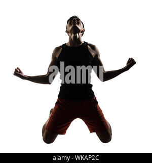 Excited young athletic man kneeling, isolated on white. Stock Photo