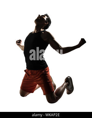 Excited young athletic man kneeling, isolated on white. Stock Photo