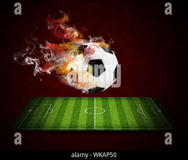 Soccer ball in the color of flame and smoke. Sport concept Stock Photo