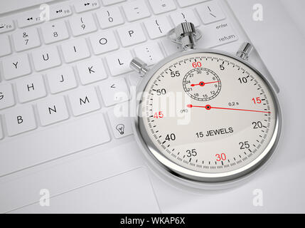Sports stopwatch lying on a computer keyboard. View from above. Stock Photo