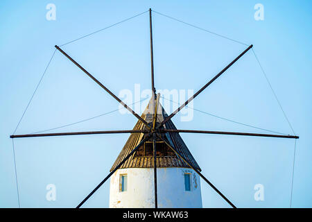 Minimalist view of antique windmill. Old wind mill against a clear blue sky. Symmetrical view of windmil in Murcia, Spain, 2019. Minimal wind mill. Stock Photo