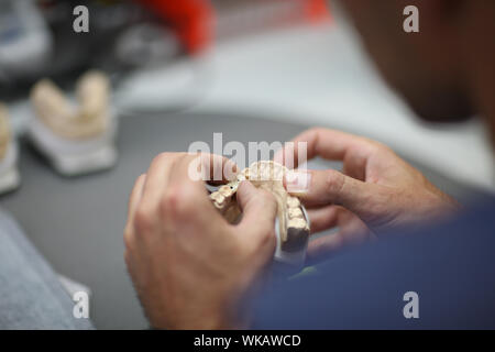 The process of manufacturing dentures in the dental laboratory Stock Photo