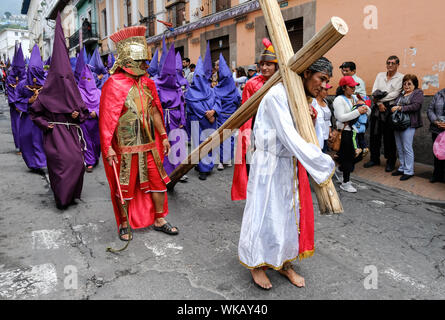 The cucuruchos of Ecuador walk the historic streets of Quito in their colourful purple robes and iconic cones on the morning of Good Friday. The proce Stock Photo