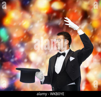 magician in top hat showing trick Stock Photo