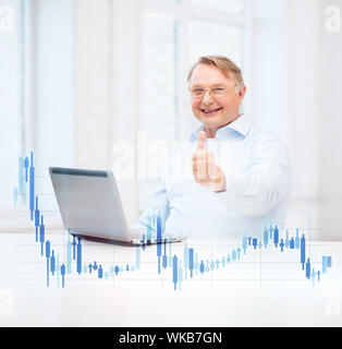 old man with laptop computer showing thumbs up Stock Photo
