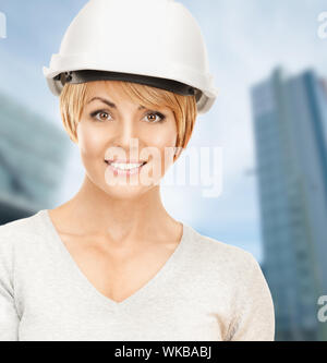 building, developing, consrtuction, architecture concept - female contractor in white helmet Stock Photo