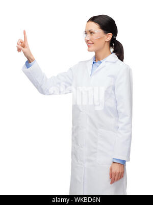 smiling female doctor pointing to something Stock Photo