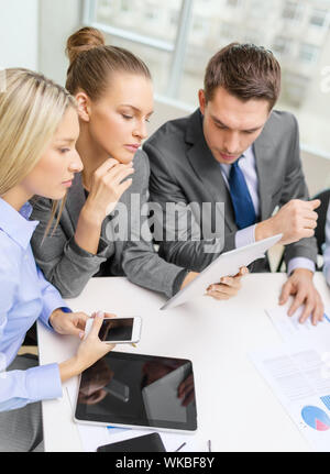 business team with tablet pc having discussion Stock Photo