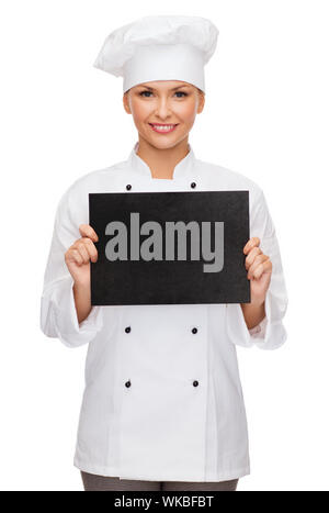 smiling female chef with black blank paper Stock Photo