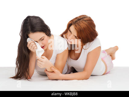 one teenage girl comforting another after break up Stock Photo