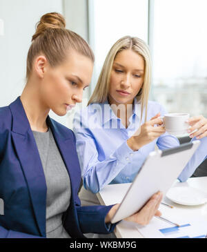 business team with tablet pc having discussion Stock Photo