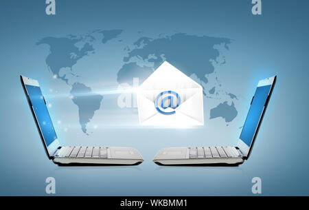 two laptop computers with world map hologram Stock Photo