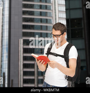 student in eyeglasses with backpack and book Stock Photo
