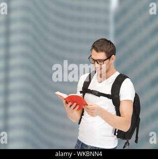 student in eyeglasses with backpack and book Stock Photo