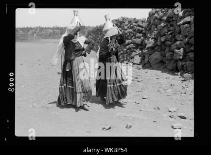 Jebel el-Druze & Hauran. Ghureye. Two Druze women with water cans & fine costumes Stock Photo