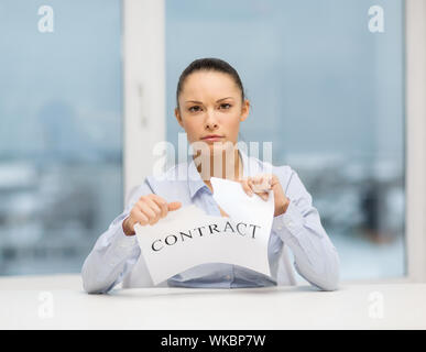 business, documents, people, legal and real estate concept - serious businesswoman tearing contract Stock Photo