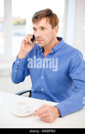 buisnessman with cell phone and cup of coffee Stock Photo