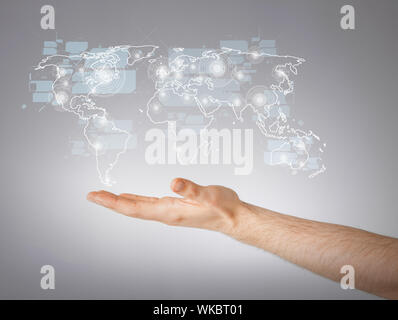 connection and future technology concept - closeup of mans hand showing world map Stock Photo