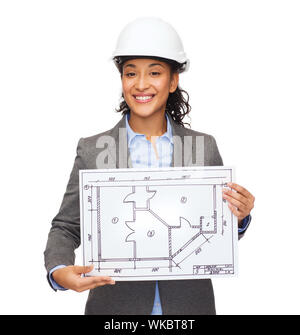 building, developing, consrtuction and architecture concept - smiling businesswoman in white helmet showing blueprint Stock Photo