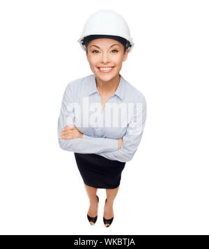 building, developing, consrtuction and architecture concept - smiling businesswoman in white helmet Stock Photo