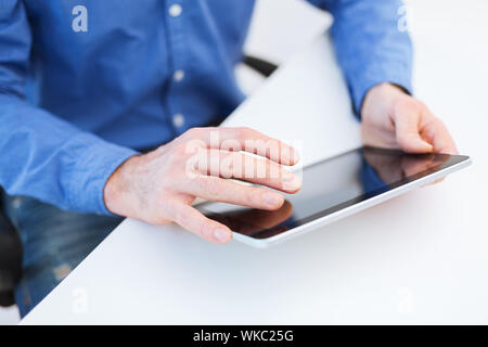 close up of male hands working with tablet pc Stock Photo