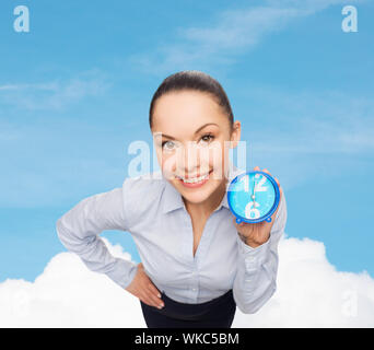 business, time and deadline concept - smiling businesswoman with blue clock Stock Photo