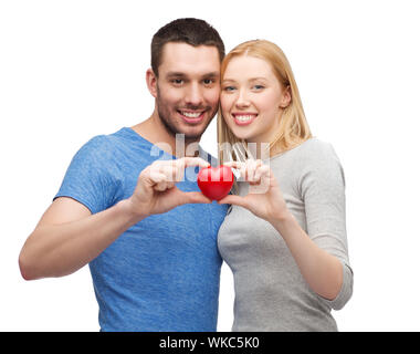 smiling couple holding small red heart Stock Photo