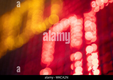 Out-of-focus effect, orange and red LED lights from the scoreboard. Suitable to be a background image. Stock Photo