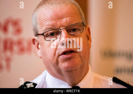 PSNI chief constable Simon Byrne speaks at the Patten 20 Years On: Young People, Policing and Stop and Search conference, in the Great Hall of Queen's University Belfast. Stock Photo