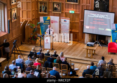 PSNI chief constable Simon Byrne speaks at the Patten 20 Years On: Young People, Policing and Stop and Search conference, in the Great Hall of Queen's University Belfast. Stock Photo