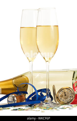 two glasses with champagne, old pocket watch, streamer, cork and confetti in front of a champagne bottle on white background Stock Photo