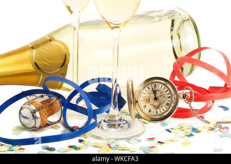 two glasses with champagne, old pocket watch, streamer, cork and confetti in front of a champagne bottle on white background Stock Photo