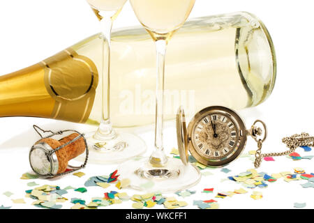 two glasses with champagne, old pocket watch, cork and confetti in front of a champagne bottle on white background Stock Photo