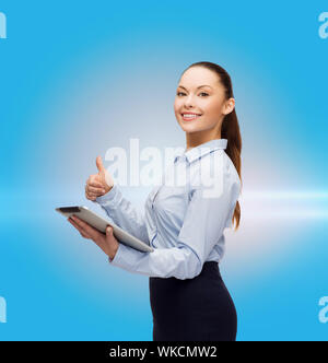 business, gesture, internet and technology concept - smiling woman looking at tablet pc computer showing thumbs up Stock Photo