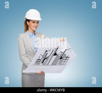 building, developing, consrtuction and architecture concept - friendly young smiling architect in white helmet with blueprints Stock Photo