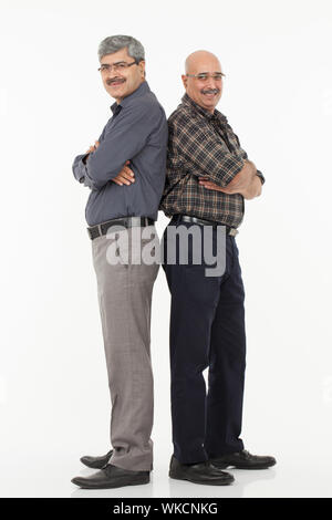 Two bald businessmen standing back to back Stock Photo - Alamy