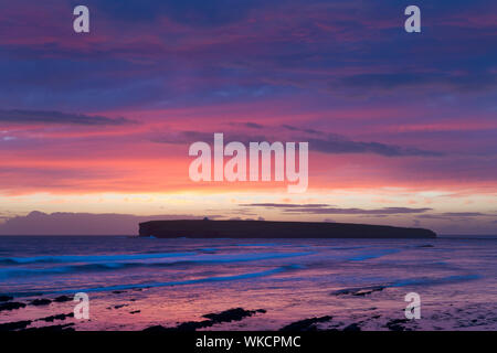 Dramatic sunlit clouds over Brough of Birsay, Orkney Isles Stock Photo