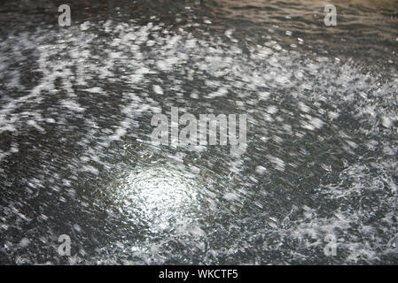 blurred grey all over background water wall with streaming water and bubbles Stock Photo
